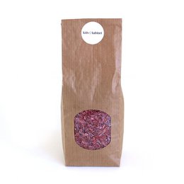 Colorful rice mix in a brown paper bag, suitable for sensory play and exploration.