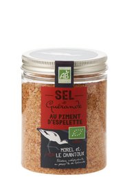 A 150g box of PGI Guérande salt with organic Espelette pepper. The salt has a reddish-brown color and a coarse, granular texture. The Espelette pepper adds a mild, slightly sweet flavor to the salt.