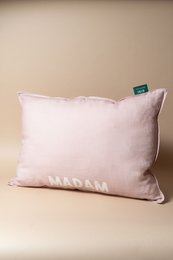  "Pale pink linen cushion with 'Madam' text, rectangular shape, soft fabric pillow"