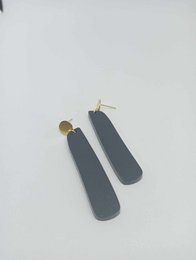  Black matte acrylic drop earrings with gold-tone hardware.