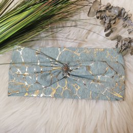 Turquoise headband with a unique dragonfly design, available in small and standard sizes.