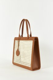 Camel-colored square handbag with woven straw-like pattern and leather trim.