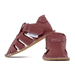 Burgundy leather slippers with adjustable straps and a flat sole. Suitable for casual wear.