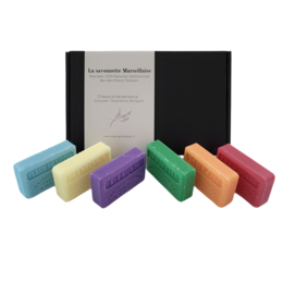 A set of 6 fragrant Marseille soap bars in various scents including lilac, mint, lotus flower, mimosa, melon, and raspberry. The bars are presented in a gift box.