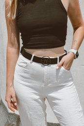 Black leather belt with monogram design, suitable for casual or formal wear.