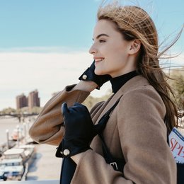 Leather gloves with a button cuff link in chocolate, black, dark navy, parchment, plum, burgundy, and red colors. Available in sizes 6 to 8.5.