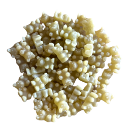 A cluster of small, white, irregular-shaped tea leaves and buds, suggesting a high-quality Turkish apple tea blend.