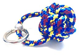 Colorful paracord keychain in blue, brown, and yellow with a ship button design. Suitable for outdoor activities and as a fashion accessory.
