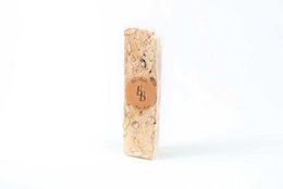  Nougat bar with visible almonds, hazelnuts, chocolate pieces, beige tan color, rectangular shape, 100g confectionery