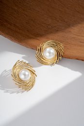 Gold spiral earrings with a central pearl, made of stainless steel.