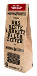 A box of the best licorice from all times, featuring a vintage-style design and text in German. The licorice is described as sweet and delicious.
