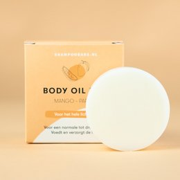 Mango and papaya-infused body oil bar with a round, solid shape. Made with natural ingredients for moisturizing skin.