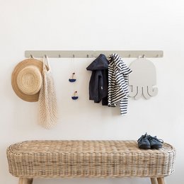 A basic coat rack with a woven bench, featuring a neutral color palette of grey, green, and yellow. The coat rack has hooks for hanging items, and the woven bench provides additional storage and seating space.